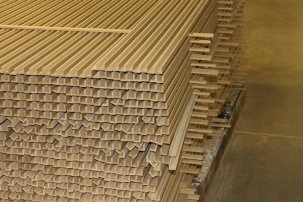 Stacked pile of wood laminate moulding.