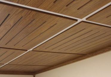 Grid wood laminate ceiling panels.