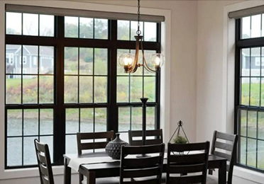 Black laminate windows with grids in a dining room.